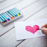 person coloring a heart